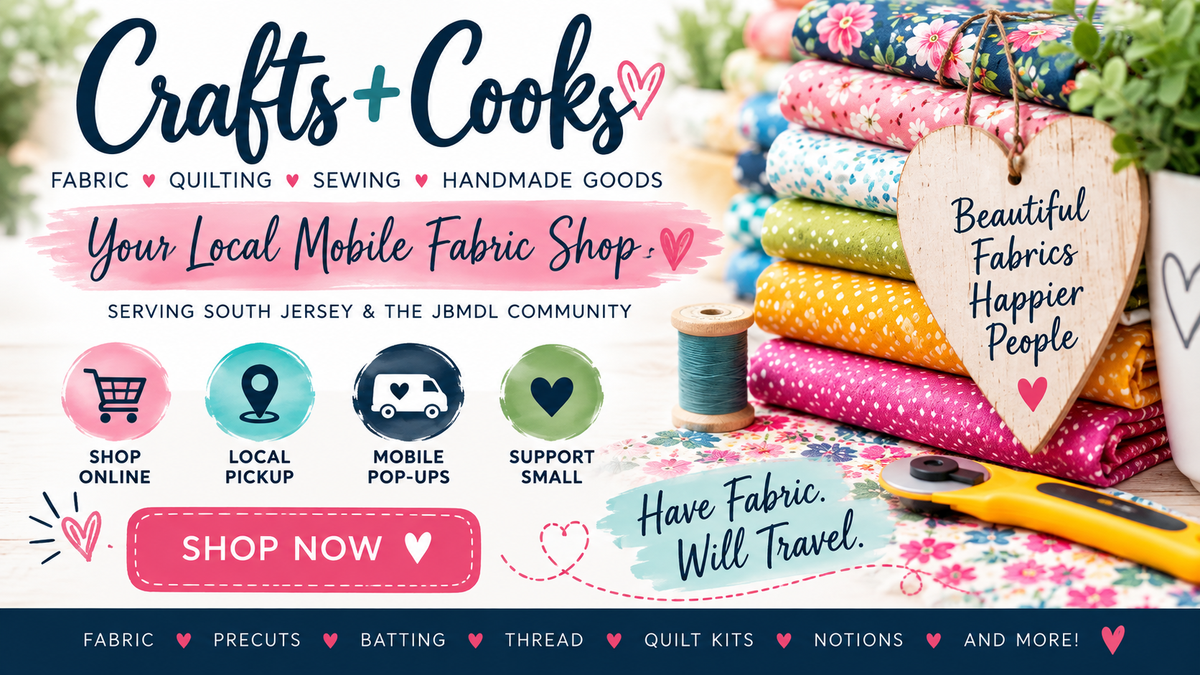 Promotional banner for 'Crafts+Cooks', a mobile fabric shop, featuring a stack of colorful patterned fabrics, a wooden heart tag, sewing notions, and text overlays advertising fabric, quilting, sewing, and handmade goods.